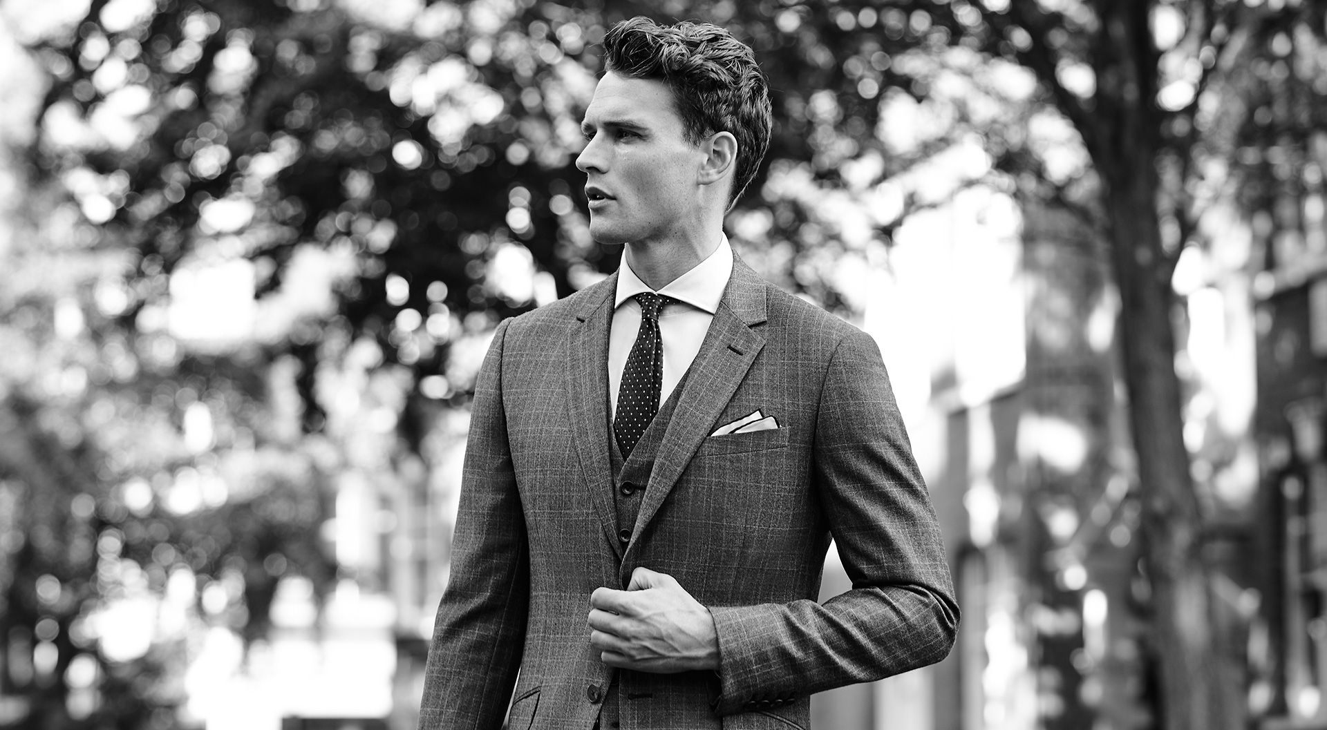 A gentleman in a tailored suit on a city street