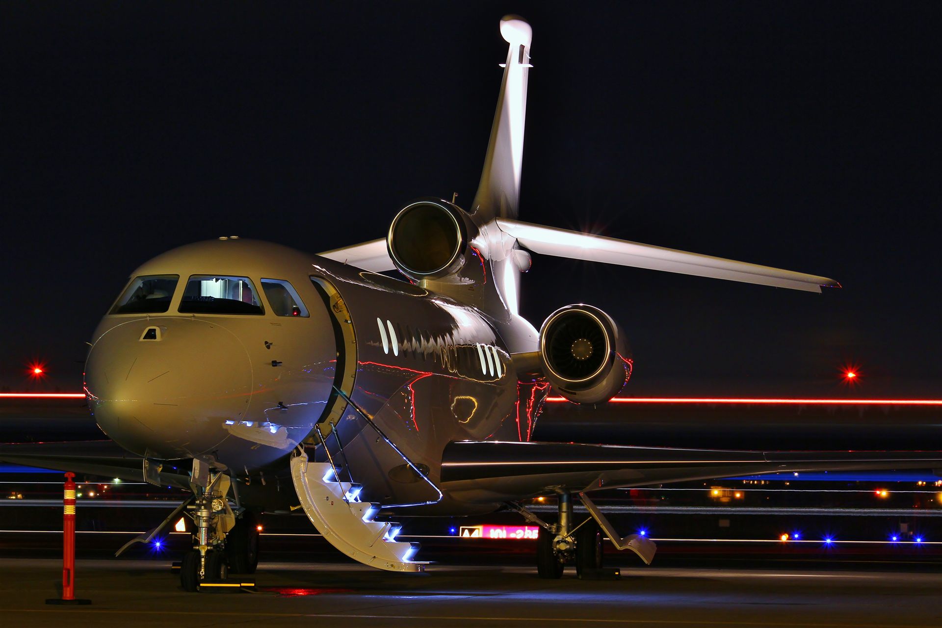 Private jet on a floodlit runway at night