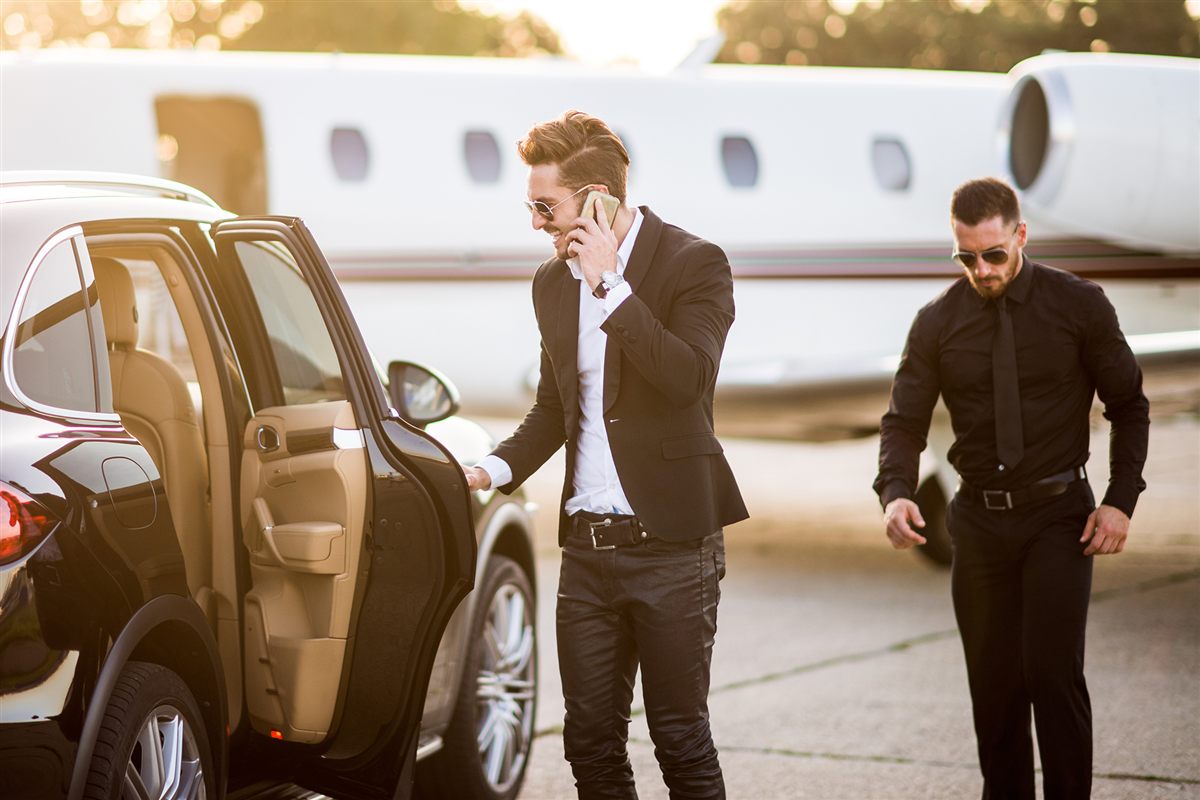 Personal security escort beside a private jet