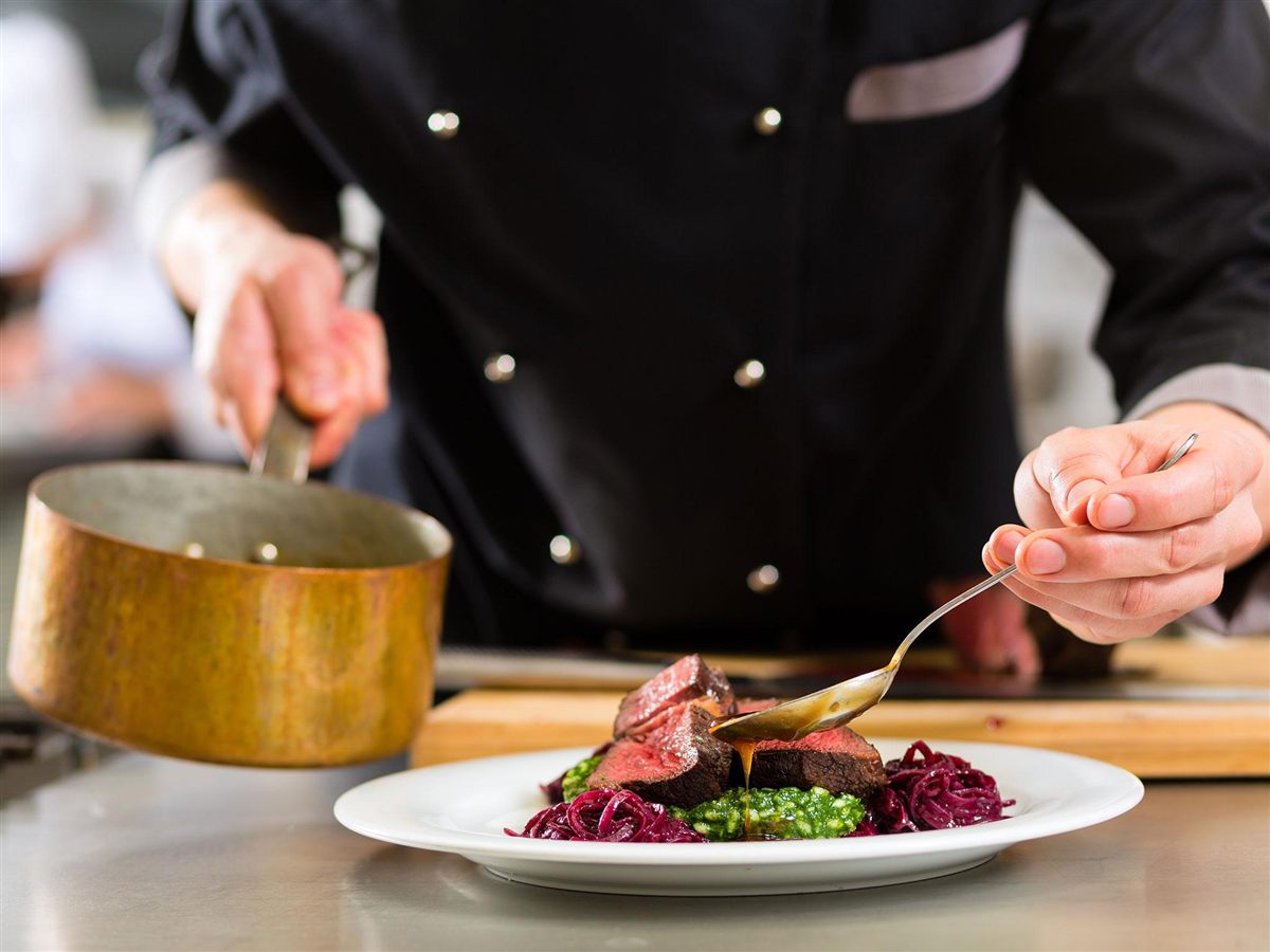 Private chef plating a fine-dining dish